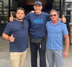Dave Daughtrey with two guests giving thumbs up after a relaxed coffee chat in San Diego